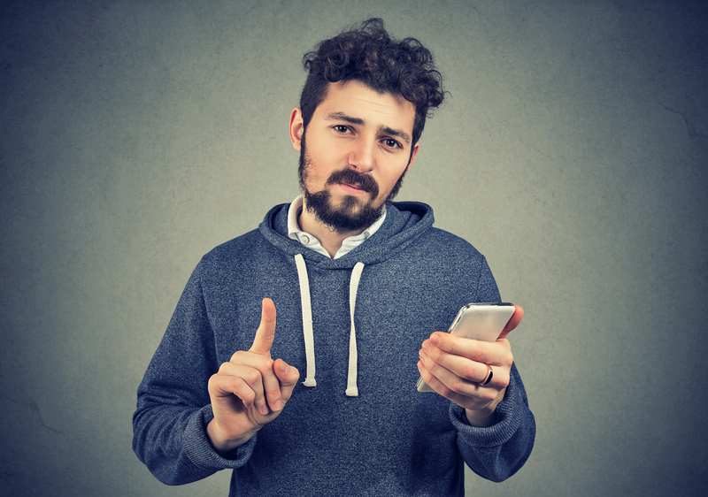 Young Man Holding Phone Clearly Setting Boundaries