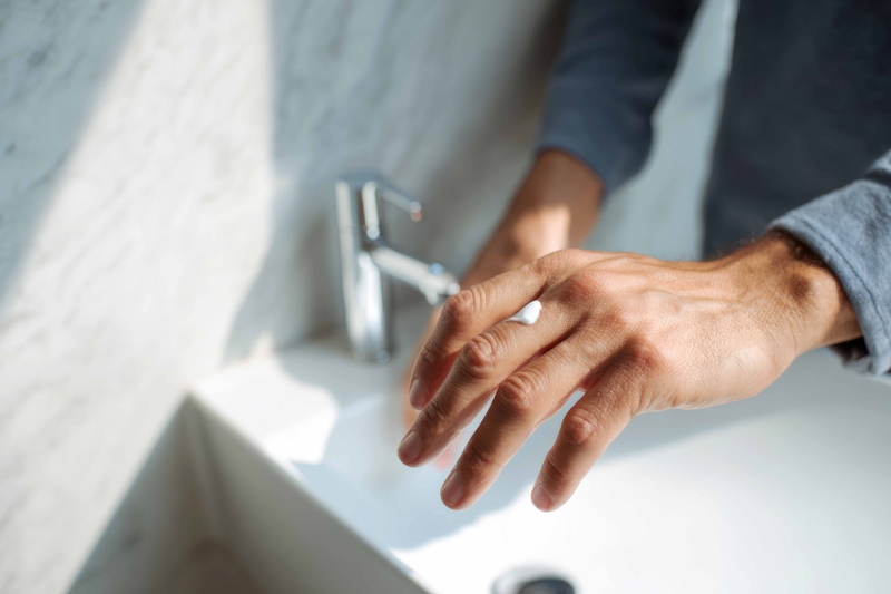 Young Person Applying Hand Lotion As A Healthy Grooming Habit