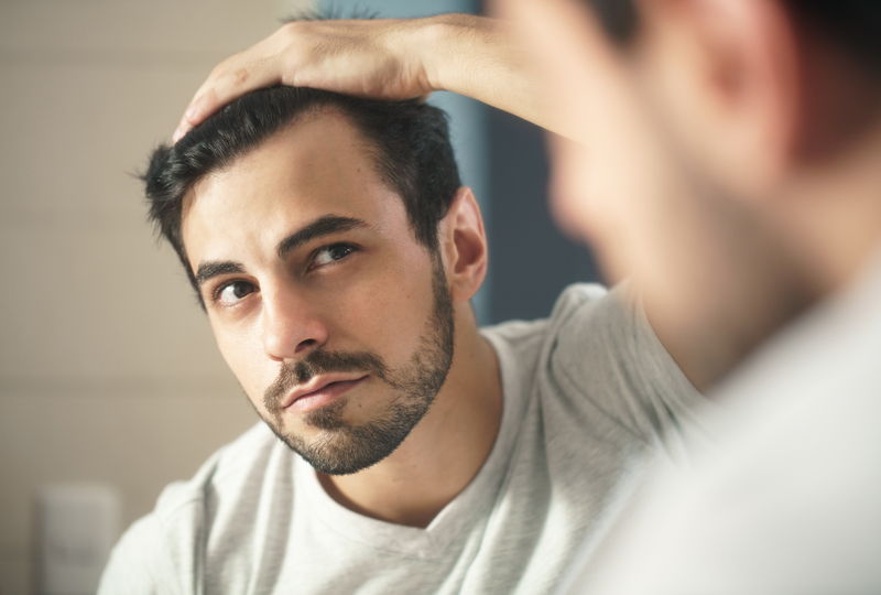 Young Man Looking After His Hair With A Simple Routine